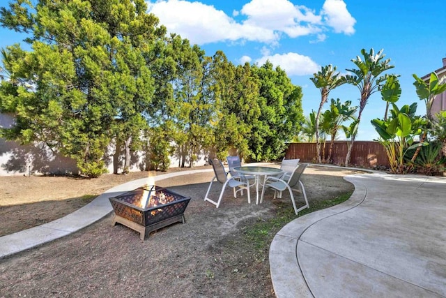 view of yard featuring a patio and an outdoor fire pit