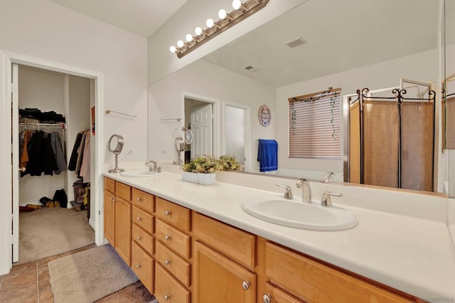 bathroom featuring tile patterned flooring and vanity