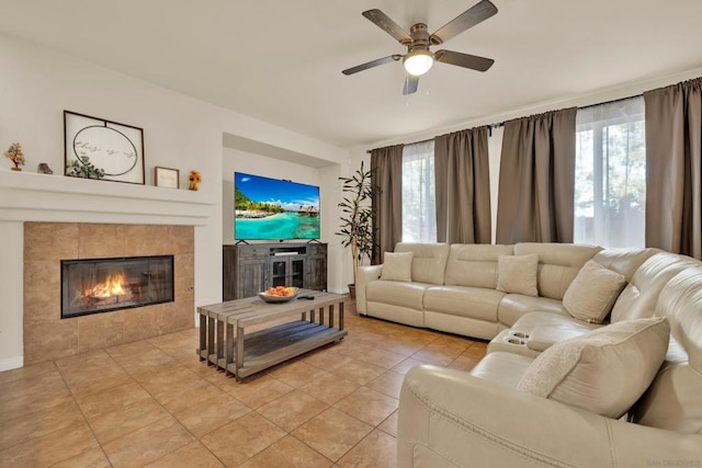 living room with plenty of natural light, ceiling fan, light tile patterned floors, and a fireplace