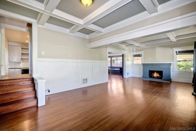 unfurnished living room featuring beamed ceiling, dark wood-type flooring, and coffered ceiling