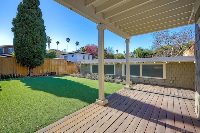 wooden deck featuring a yard