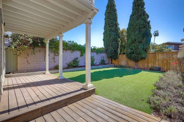 wooden terrace with a lawn