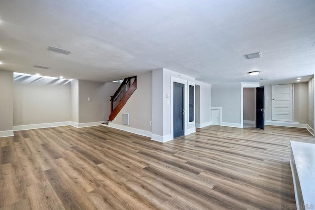 basement with light hardwood / wood-style flooring