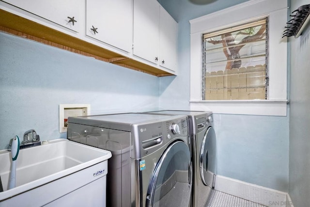 washroom featuring tile patterned flooring, cabinets, separate washer and dryer, and sink