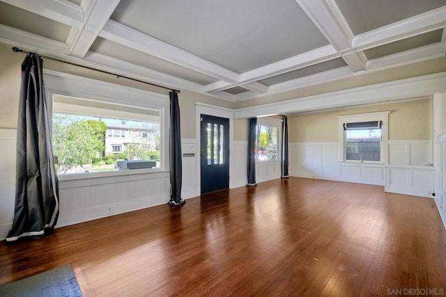 spare room featuring hardwood / wood-style flooring, plenty of natural light, and beam ceiling