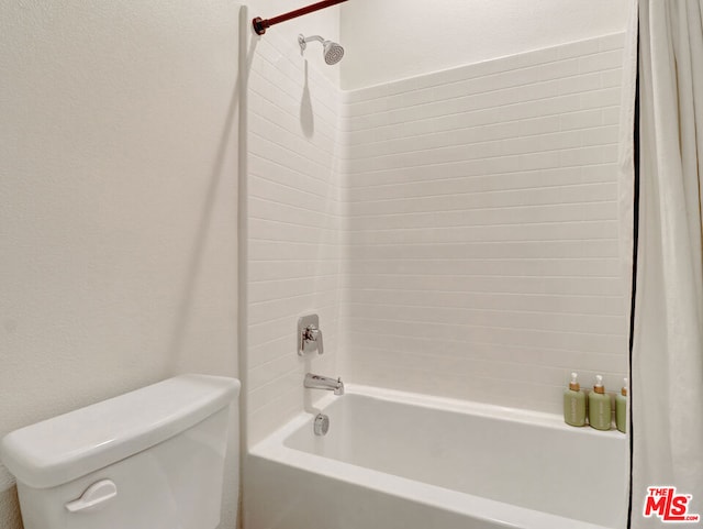 bathroom with bathtub / shower combination and toilet