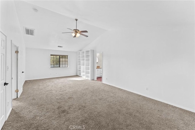 spare room featuring carpet flooring, ceiling fan, and lofted ceiling