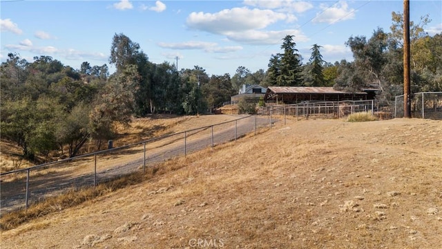 view of yard with a rural view and an outdoor structure