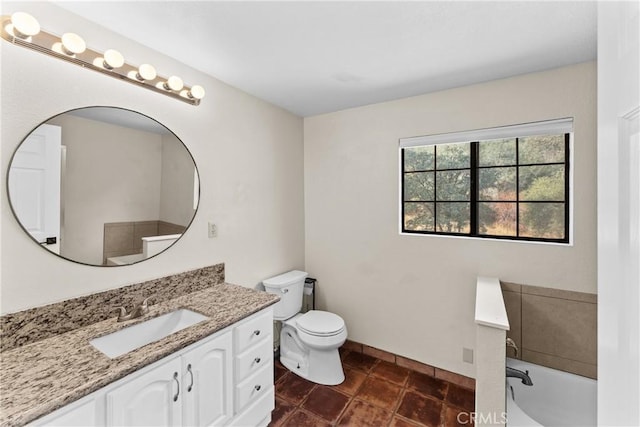 bathroom with vanity, toilet, and a washtub