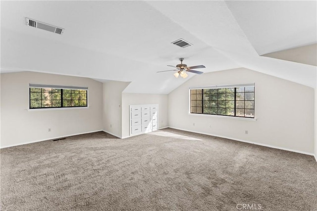 additional living space with carpet flooring, ceiling fan, and lofted ceiling