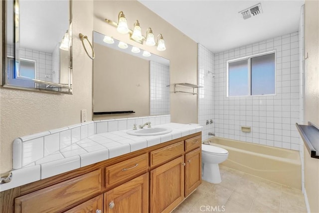 full bathroom with tile patterned floors, vanity, toilet, and tiled shower / bath combo