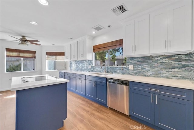 kitchen with a healthy amount of sunlight, white cabinets, and stainless steel dishwasher