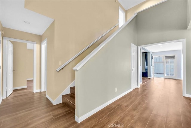 corridor with hardwood / wood-style flooring