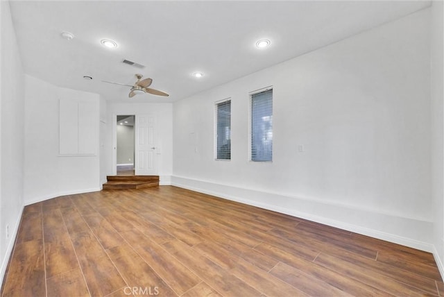 empty room featuring ceiling fan and hardwood / wood-style flooring