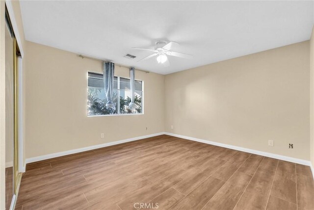 unfurnished room featuring hardwood / wood-style floors and ceiling fan