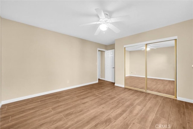 unfurnished bedroom featuring a closet, ceiling fan, and hardwood / wood-style floors