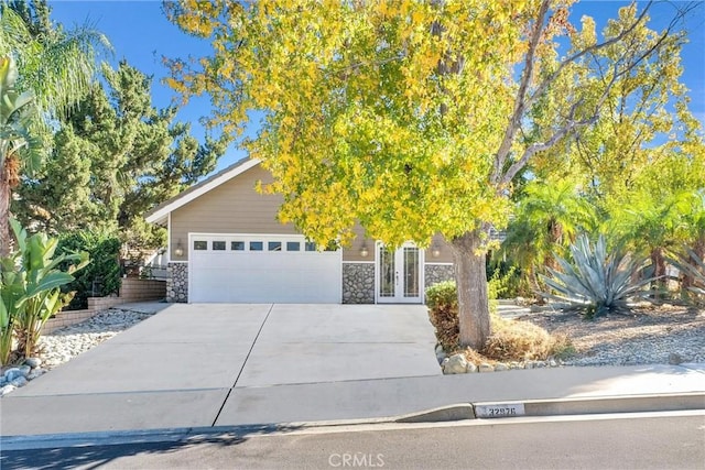 obstructed view of property with french doors and a garage