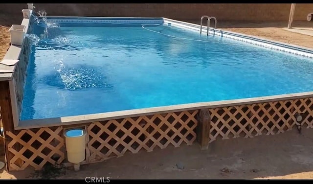 view of pool with pool water feature