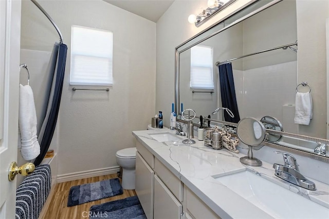 full bathroom with vanity, wood-type flooring, toilet, and shower / bath combo with shower curtain