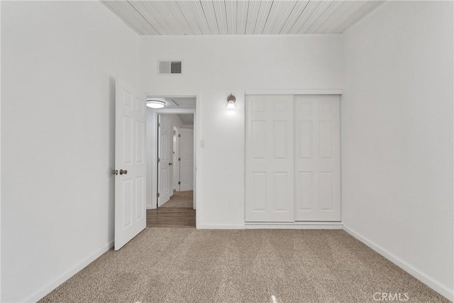 unfurnished bedroom with carpet floors and a closet