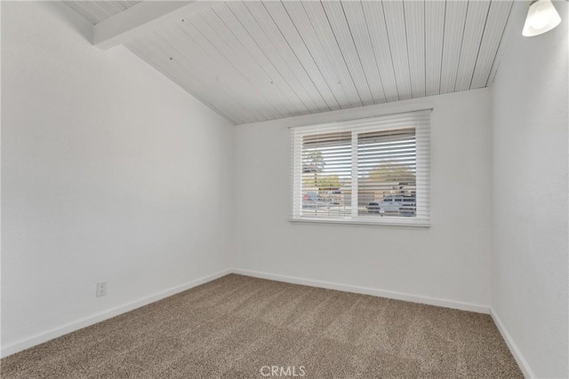 carpeted spare room featuring wooden ceiling and lofted ceiling with beams