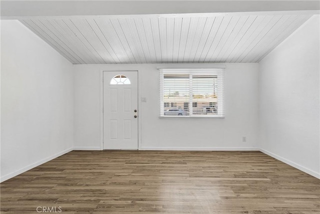 entryway featuring wooden ceiling, baseboards, and wood finished floors