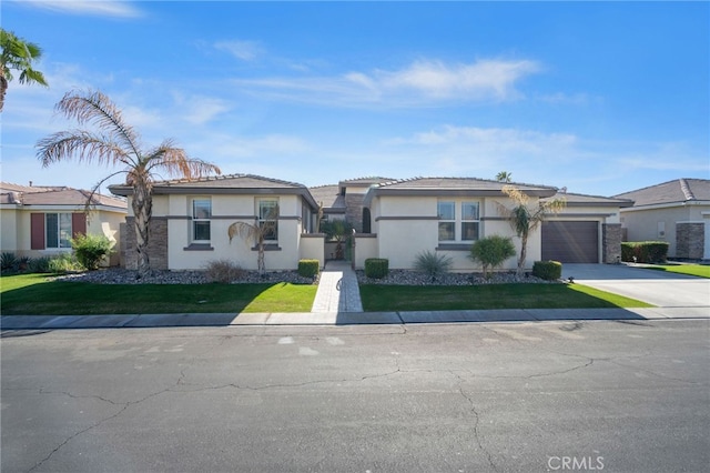 view of front of house featuring a garage, stucco siding, concrete driveway, and a front yard