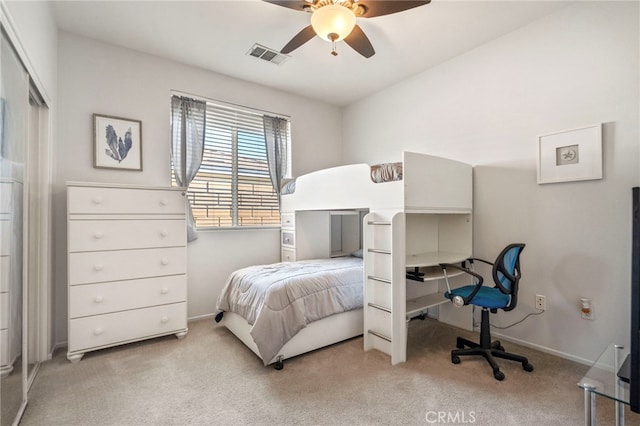 bedroom featuring ceiling fan, light colored carpet, and a closet