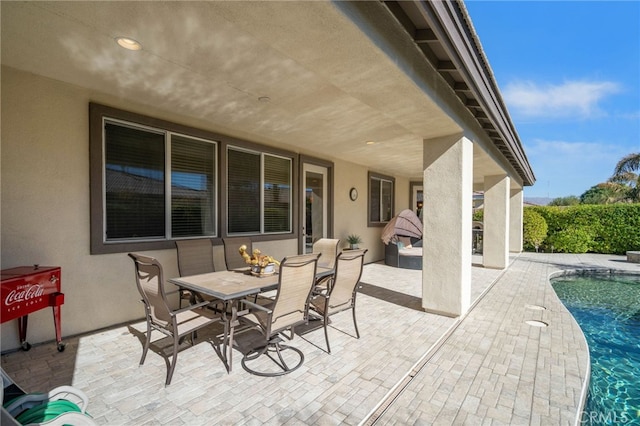 view of patio / terrace with a fenced in pool and outdoor dining area