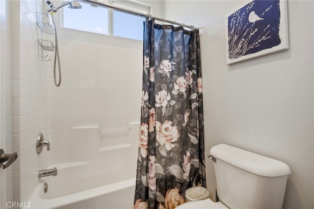 bathroom featuring shower / tub combo with curtain and toilet