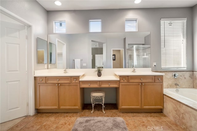 bathroom with tile patterned floors, vanity, and shower with separate bathtub