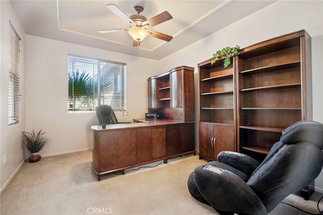 carpeted office space with ceiling fan