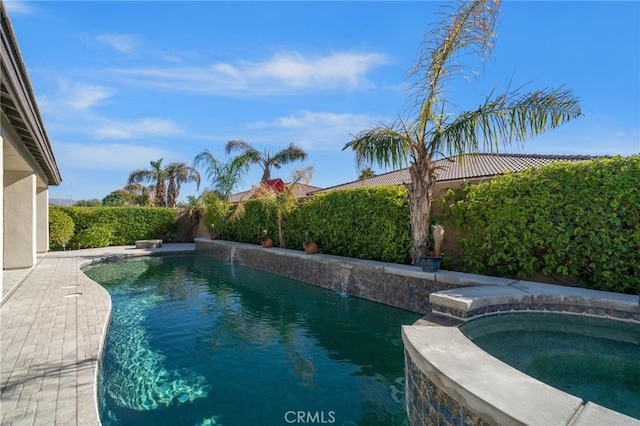 view of swimming pool featuring a pool with connected hot tub and a fenced backyard