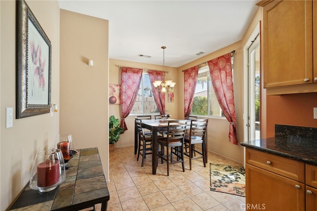 dining room with a notable chandelier and light tile patterned floors