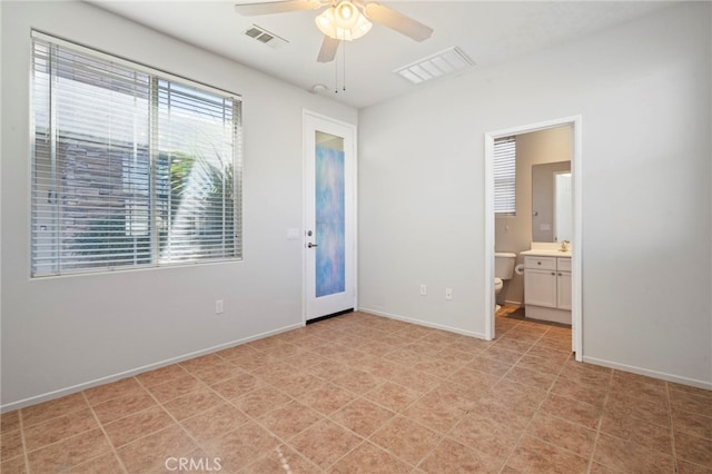 empty room with a ceiling fan, baseboards, visible vents, and a sink