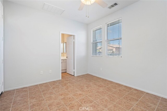 unfurnished bedroom featuring visible vents, ceiling fan, ensuite bathroom, and baseboards