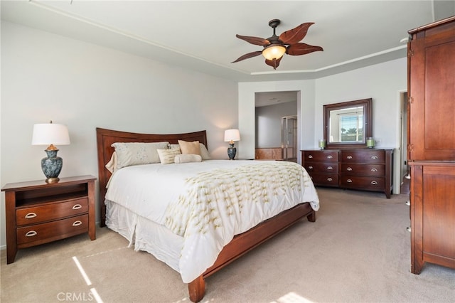 bedroom featuring light carpet and a ceiling fan