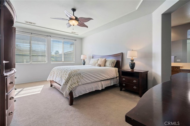 bedroom featuring visible vents, light colored carpet, and a ceiling fan