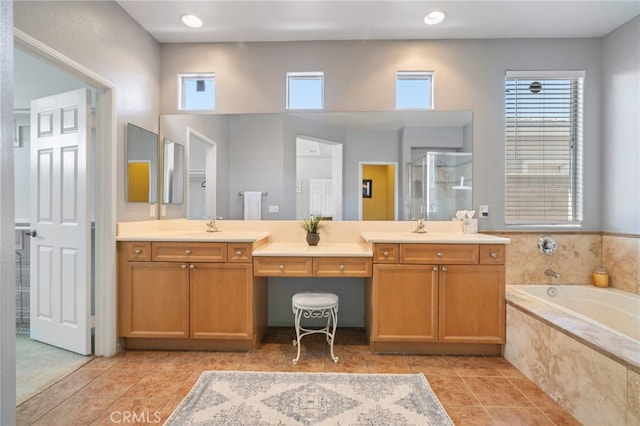 full bathroom with tile patterned flooring, a shower stall, vanity, and a garden tub
