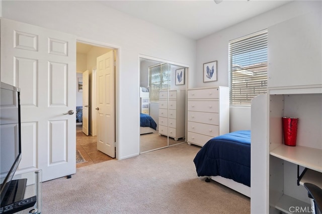 carpeted bedroom with multiple windows and a closet