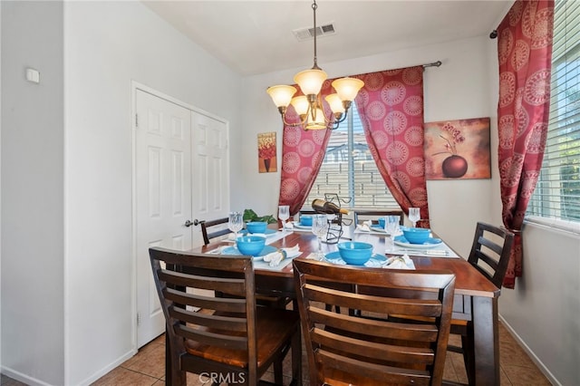 tiled dining area featuring visible vents, baseboards, and a chandelier