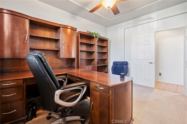 office with a ceiling fan, light tile patterned flooring, and light colored carpet
