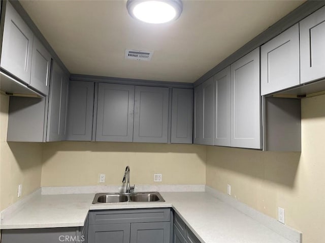 kitchen featuring gray cabinetry and sink