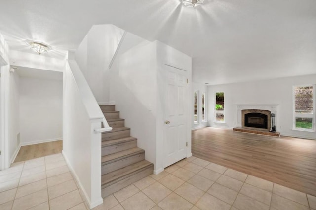 staircase with tile patterned floors and plenty of natural light