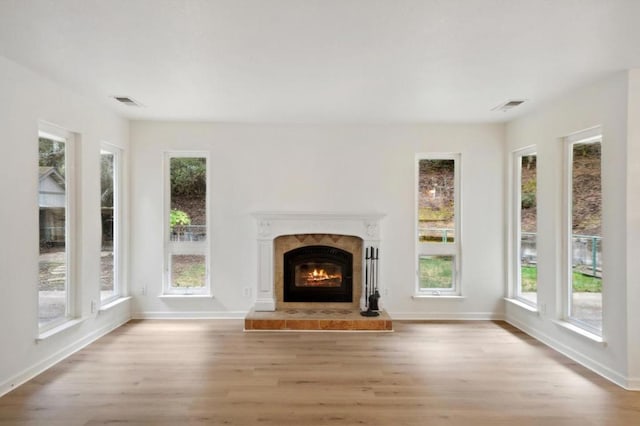 unfurnished living room with plenty of natural light and light wood-type flooring