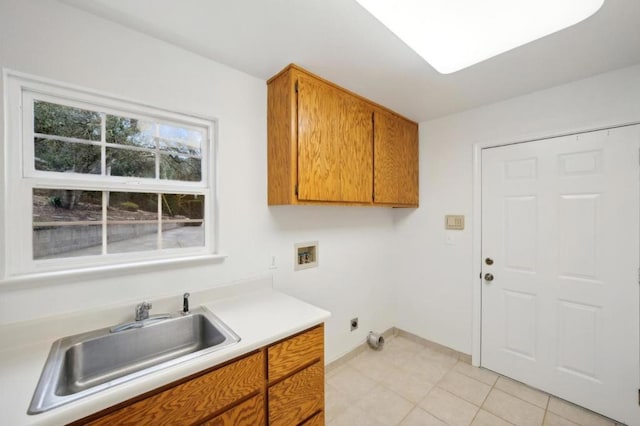 laundry room featuring sink, light tile patterned floors, electric dryer hookup, hookup for a washing machine, and cabinets