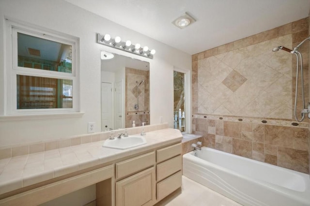 bathroom featuring vanity and tiled shower / bath combo