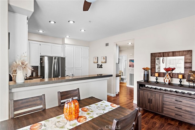 dining room with visible vents, a ceiling fan, dark wood finished floors, recessed lighting, and baseboards