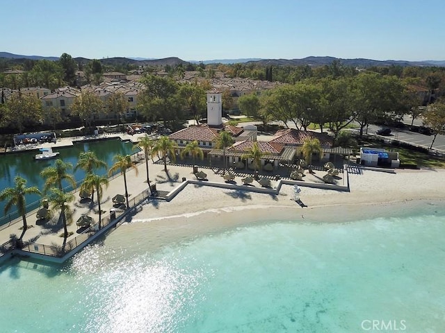 birds eye view of property with a water and mountain view