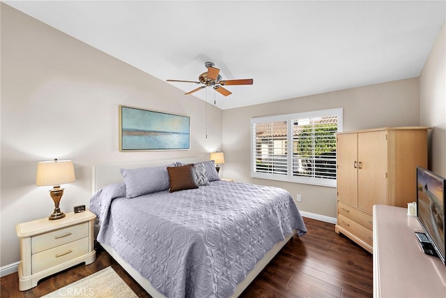 bedroom featuring baseboards, lofted ceiling, dark wood-type flooring, and ceiling fan